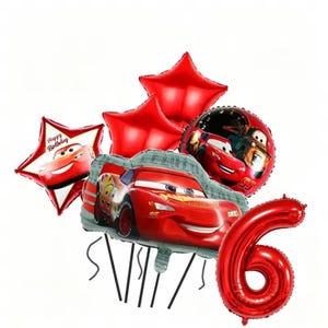 May include: A set of red foil balloons featuring Lightning McQueen from the Cars film. Includes star-shaped balloons, a round balloon, and a number 6 balloon. One star-shaped balloon has the text "Happy Birthday".