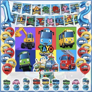 May include: A colorful birthday party decoration set featuring a banner that reads "HAPPY BIRTHDAY", blue number balloons, and character-themed balloons. The set includes cake toppers and cupcake decorations with bus and vehicle designs.