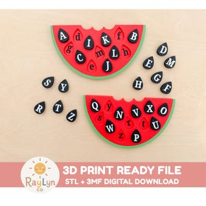 May include: Two red watermelon-shaped boards with green rinds and black teardrop-shaped letter tiles. The tiles feature white uppercase and lowercase letters. Text at the bottom reads: 3D PRINT READY FILE STL + 3MF DIGITAL DOWNLOAD RayLyn co.