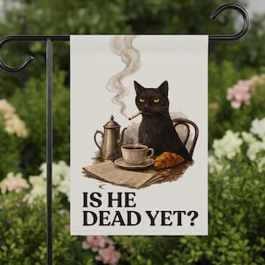 May include: A rectangular garden flag featuring a black cat sitting at a table with a coffee pot, a cup of coffee, a croissant, and a newspaper. The cat has a cigarette in its mouth. The text IS HE DEAD YET? is printed in black at the bottom.