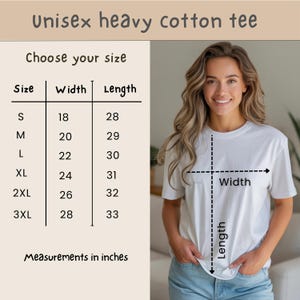 Op de afbeelding: Een wit unisex zwaar katoenen t-shirt wordt in deze afbeelding getoond. De maattabel toont afmetingen in inches, met breedtes vari&euml;rend van 45.7 tot 71.1 cm en lengtes van 71.1 tot 83.8 cm. De tekst "Unisex heavy cotton tee" staat bovenaan.