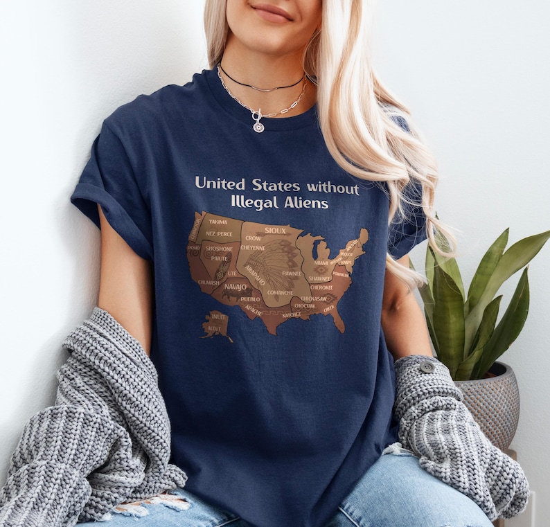 K&ouml;nnte beinhalten: Marineblaues T-Shirt mit dem Text "United States without Illegal Aliens" &uuml;ber einer braunen Karte der Vereinigten Staaten. Die Karte enth&auml;lt die Namen der amerikanischen Ureinwohner. Das T-Shirt wird getragen.
