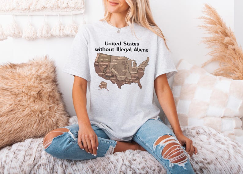 K&ouml;nnte beinhalten: Hellgraues T-Shirt mit einer braunen Karte der Vereinigten Staaten und den Namen der Bundesstaaten. Der Text "United States without Illegal Aliens" ist &uuml;ber der Karte aufgedruckt. Das T-Shirt wird getragen.