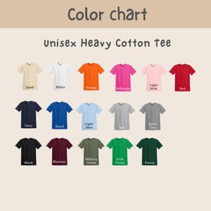 Op de afbeelding: Een kleurenkaart met een verscheidenheid aan unisex heavy cotton t-shirts. Kleuren zijn zand, wit, oranje, helliconia, lichtroze, rood, marine, koninklijk, lichtblauw, as, sportgrijs, zwart, kastanjebruin, legergroen, Iers groen en bos.