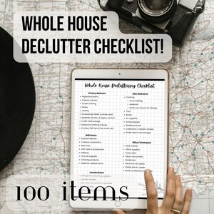 May include: A digital tablet displays a "Whole House Declutter Checklist" with categories like Primary Bedroom, Kids' Bedrooms, and Office/Workspace. The checklist includes 100 items to declutter. A vintage camera sits above the tablet.