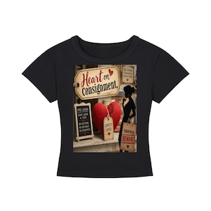 May include: A black short-sleeved t-shirt featuring a graphic print of a red heart, a silhouette of a person, and signs with text including Heart on Consignment, Pre-Loved, Some Wear & Tear, No Returns, No Guarantees, Gently Loved, and Shopper Beware.