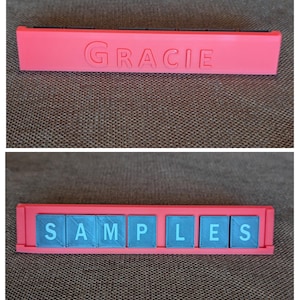 May include: A coral-colored nameplate with the name "GRACIE" embossed on it. Below, a similar nameplate holds blue tiles spelling "SAMPLES". The nameplates are rectangular and appear to be 3D-printed.