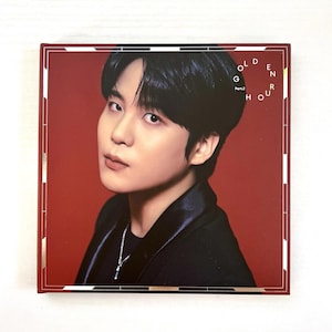 May include: A square album cover featuring a person with black hair and a black jacket against a red background. The album title "GOLDEN HOUR Part.2" is printed in white on the right side of the cover.
