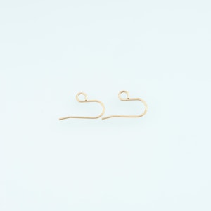 May include: A pair of gold-toned metal earring hooks, each featuring a curved wire design with a small circular loop at the top for attaching jewelry components. The hooks have a smooth, polished finish and a simple, functional U-shaped structure.