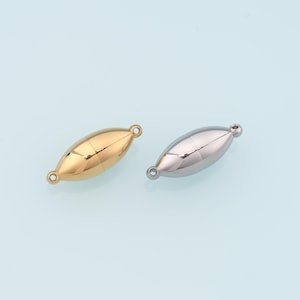 May include: Two oval-shaped magnetic clasps. One is gold-colored, the other is silver. Each clasp has a small loop on each end. The clasps are designed for jewelry making and crafting.
