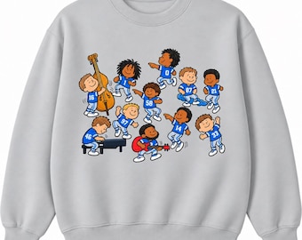 May include: A light gray crewneck sweatshirt featuring a graphic print of cartoon characters wearing blue football jerseys with various numbers. The characters are depicted playing musical instruments including a double bass, a piano, and a red electric guitar.