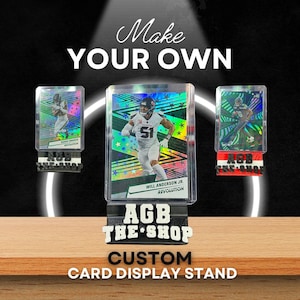 May include: Three custom card display stands with sports cards. The stands are black with the text "AGB THE SHOP". The cards feature football players. The text "Make YOUR OWN" and "CUSTOM CARD DISPLAY STAND" are also visible.