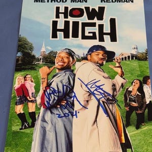 May include: A movie poster for "How High" featuring Method Man and Redman. The poster has the movie title in large white letters with a red "O". The actors are standing back-to-back on a green field, with signatures in blue ink.