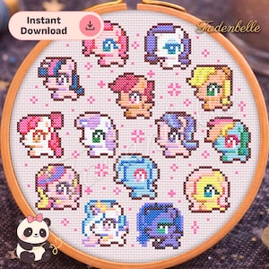 May include: A cross-stitch embroidery hoop featuring a collection of colorful cartoon pony designs. The ponies have various hair colors and styles, set against a white fabric background. The text "Instant Download" is visible. The hoop is framed in a wooden ring.