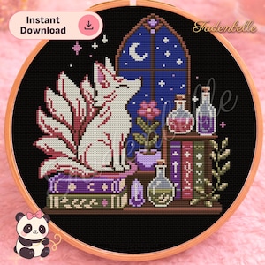 May include: A cross-stitch pattern in a wooden hoop featuring a white nine-tailed fox sitting on purple and green books. The scene includes a blue arched window with a crescent moon, a potted pink flower, glass potion bottles, and crystals.