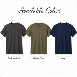 May include: Three short-sleeved crew neck t-shirts displayed in a row with the text Available Colors at the top. The shirts are colored dark heather, military green, and navy, with corresponding labels below each shirt identifying the color.