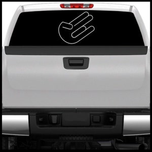 May include: A white truck with a white hand gesture sticker on the back window. The sticker is a stylized hand with three fingers extended.