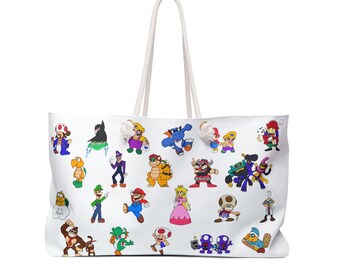 May include: A white tote bag with two thick rope handles featuring a colorful pattern of various Nintendo video game characters including Mario, Luigi, Princess Peach, Bowser, Toad, Yoshi, Donkey Kong, and Wario printed across the front surface.