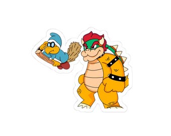 May include: A die-cut sticker featuring a yellow turtle-like creature with a blue hat and glasses flying on a wooden broomstick next to a large, orange, reptilian character with red hair, a spiked shell, and black wristbands with silver studs.