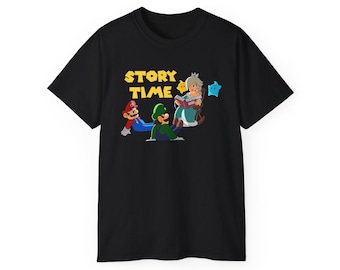 May include: A black short-sleeve t-shirt featuring a graphic print of Mario, Luigi, and Princess Rosalina sitting together. The text "STORY TIME" is printed in yellow above the characters, who are accompanied by two small floating star figures.