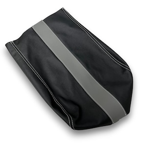 May include: Black leather bag with a wide gray stripe down the center. The bag has white stitching along the edges and the gray stripe. The bag is made of a textured material.