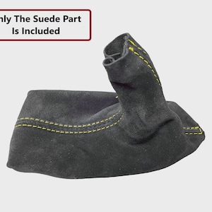 May include: Black suede shift boot with yellow stitching. The text "Only The Suede Part Is Included" is in a white box with a maroon border. The boot is a car interior accessory.