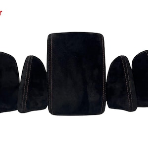 May include: A collection of five black suede car interior components with red stitching. The set includes a large rectangular centre console cover and four smaller, curved seat covers. The word "After" is in red in the top left corner.