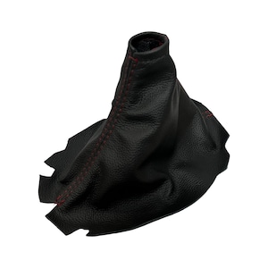 May include: A black leather shift boot with red stitching. The boot is shaped like a cone and is designed to cover the gear shift lever in a vehicle. The stitching is visible along the seam.