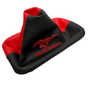May include: A black and red shift boot with the word "MUSTANG" embroidered in white. The shift boot has a red stitched seam and a red Mustang logo.
