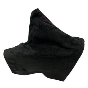 May include: A black fabric gear stick gaiter with red stitching. The gaiter is made of a soft, textured material and is designed to fit over a vehicle's gear stick. The gaiter has a unique shape and is likely a custom or aftermarket part.