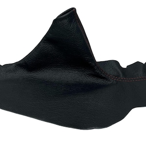 May include: A black leather shift boot with red stitching. The boot is made of a textured material and has a cone-like shape. The stitching is visible along the edges of the boot.