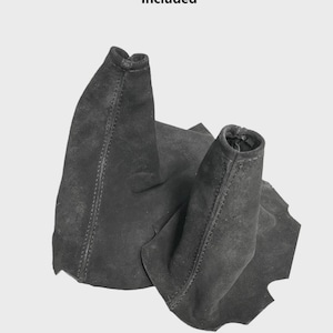 May include: Two black suede manual transmission shift boots. The text "Only The Uni Suede Part Is Included" and "Manual Transmission" are visible. The boots are made of a soft, dark material.