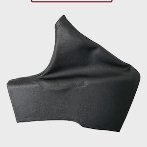 May include: A black leather item with a textured finish. The product is shaped like a sleeve or cover, featuring a folded top and a rectangular base. The text "Only The Real Leather Is Included" is displayed in a red-bordered box.