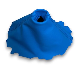 May include: A vibrant blue shift boot cover with a scalloped edge. The boot is made of a smooth material and features dark blue stitching. The top has a circular opening. The item is set against a white background.