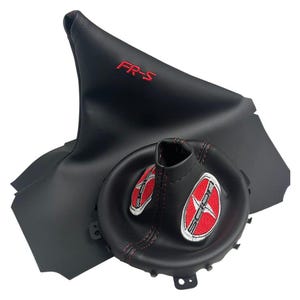 May include: Black leather shift boot and console cover with red stitching. The shift boot has the text "FR-S" in red. The console cover has two Scion logos with red starbursts.