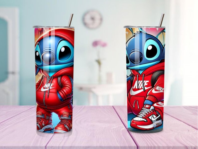 May include: Two stainless steel tumblers featuring a cartoon character in a red Nike tracksuit. The character is blue with large black eyes. The tumblers have a silver straw and a silver lid. The background is blurred.