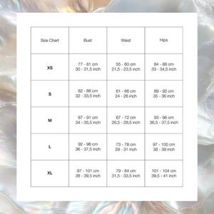 May include: A white size chart with measurements for bust, waist, and hips in both centimeters and inches. Sizes range from XS to XL. The chart is against a blurred, iridescent background.