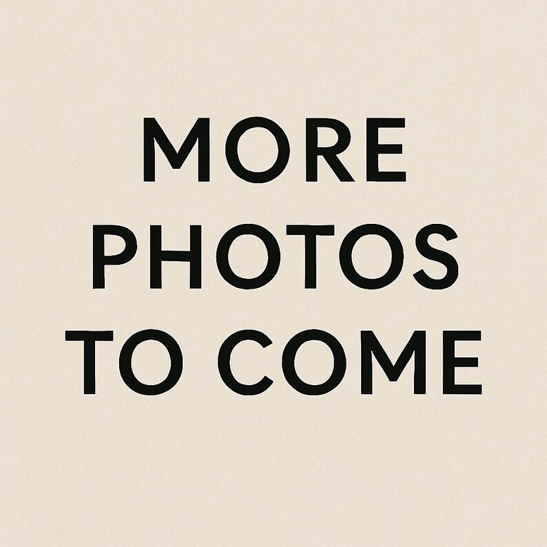 May include: Text on a beige background reads "MORE PHOTOS TO COME" in a bold, black font. The text is centered and stacked vertically, indicating additional product images will be available.