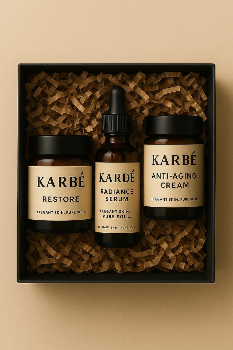 May include: A skincare gift set in a black box with shredded paper filler. The set includes three dark glass bottles and jars with black lids. The labels read "KARB&Eacute;" and list the products as "RESTORE", "RADIANCE SERUM", and "ANTI-AGING CREAM".