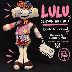 May include: A handmade fabric art doll named Lulu with multicolored yarn hair, blue eyes, and a patchwork outfit. The doll features a clip-on attachment and a white tag labeled Lulu with a panda icon. Text on the image reads LULU CLIP-ON ART DOLL, Urchin to Be Loved, Handmade by Rebecca Coppock, Little Panda Acts of Kindness, and ONE OF A KIND.