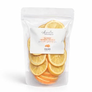 A clear plastic bag filled with freeze-dried orange slices.