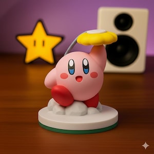 May include: A pink Kirby figurine holding a yellow flower, standing on a white base with a green border. The figurine has red feet and cheeks, and blue eyes. A yellow star-shaped light is in the background.