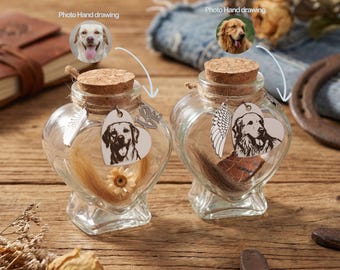 May include: Two heart-shaped glass keepsake bottles with cork stoppers. Each bottle contains pet fur and a heart-shaped charm with a dog portrait. One charm has angel wings, the other has a love charm. A small flower is inside one bottle.