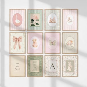 May include: Twelve framed art prints with a vintage aesthetic. The prints feature illustrations of a swan, a bow, a teddy bear, a butterfly, a bicycle, a goose, a floral arrangement, rabbits, and the letter "A". The colour palette includes soft pinks, greens, and creams.