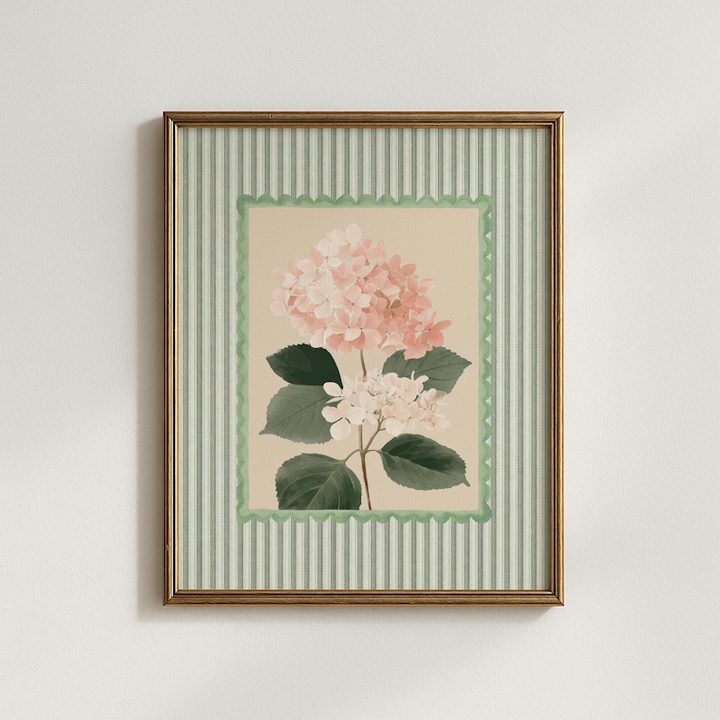 May include: A framed floral print of a hydrangea. The artwork features pink and white flowers, green leaves, and a beige background. It is framed with a green scalloped border and a striped green and white frame. The frame is gold.