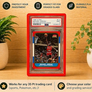 May include: A red 3D-printed graded card slab bumper with the text "3D Printed GRADED CARD SLAB BUMPER". The bumper protects a Michael Jordan trading card. The text on the card reads "1996 ULTRA MICHAEL JORDAN DECADE OF EXCELLENCE".