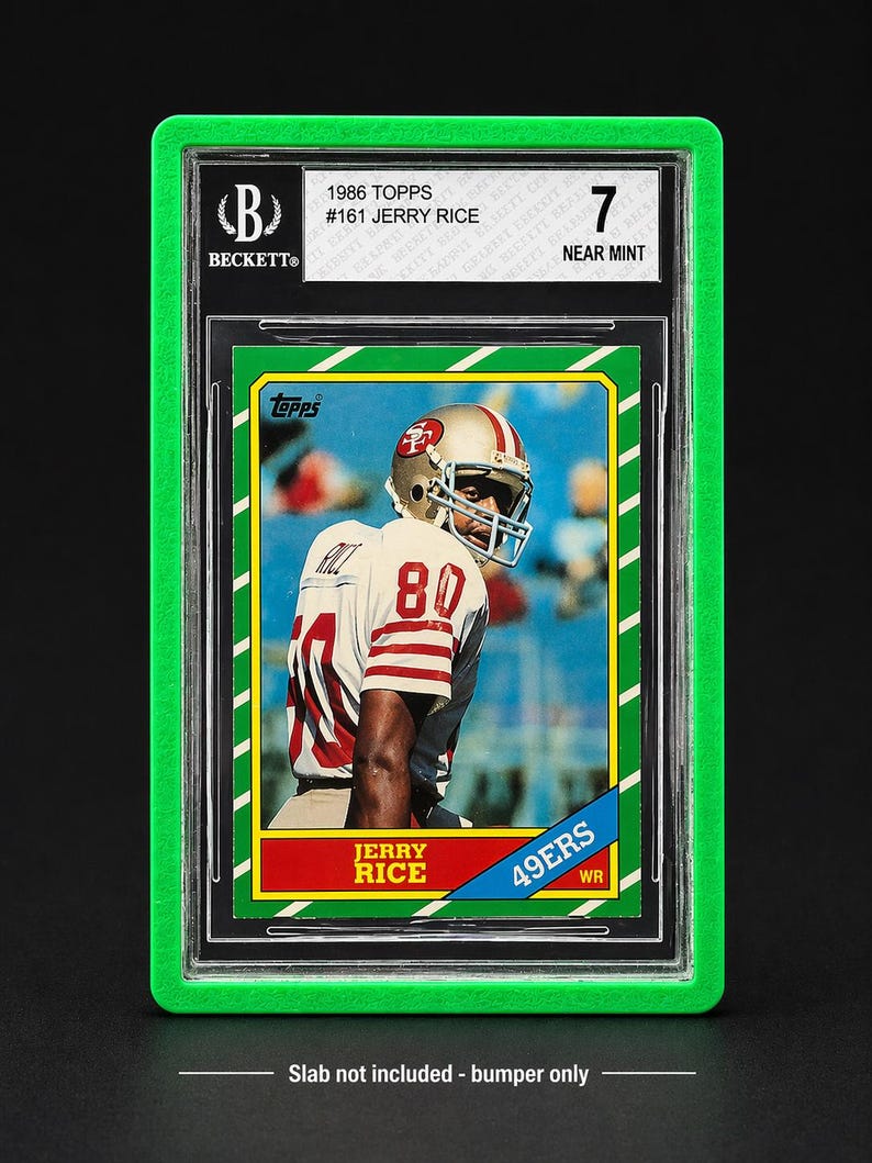 May include: A graded 1986 Topps football card of Jerry Rice, encased in a green protective holder. The card features Rice in his 49ers uniform, with the number 80 visible. The card is graded a 7, labeled "Near Mint".