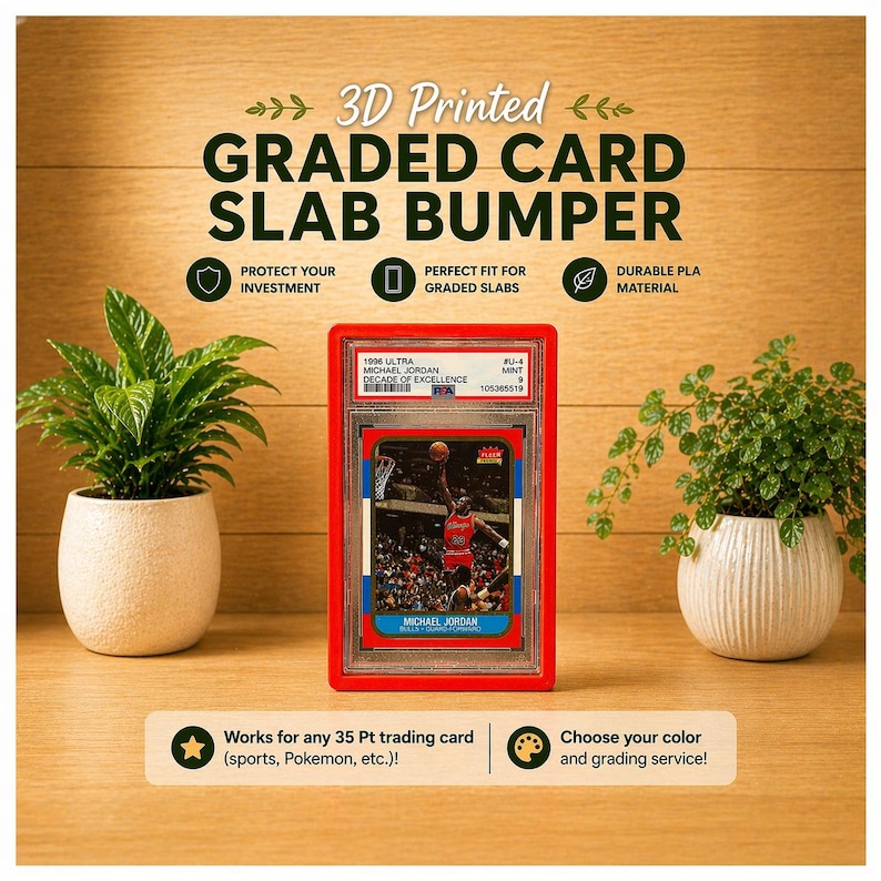May include: A red 3D-printed graded card slab bumper with the text "3D Printed GRADED CARD SLAB BUMPER". The bumper protects a Michael Jordan trading card. The text on the card reads "1996 ULTRA MICHAEL JORDAN DECADE OF EXCELLENCE".