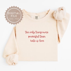 May include: A white ceramic mug with a black handle and the text "But First, Coffee" in a bold, black font. The mug is set against a blurred background, suggesting a cosy setting.