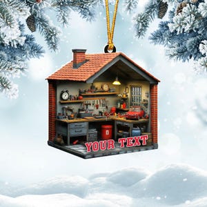 May include: A detailed Christmas ornament shaped like a miniature workshop. The ornament features a red brick chimney, a red car, and the text "YOUR TEXT" in a red banner. Tools and equipment are visible inside the workshop.